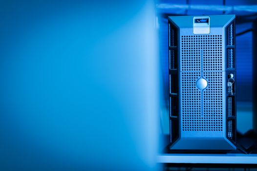 Close-up of modern server unit in blue-lit data center environment
