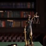 Lady Justice statue and gavel in law library