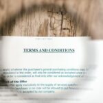Magnifying glass focusing on terms and conditions document