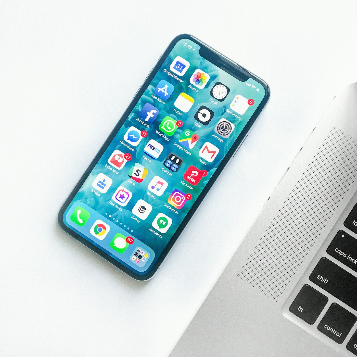 Smartphone held in hand with a lit screen