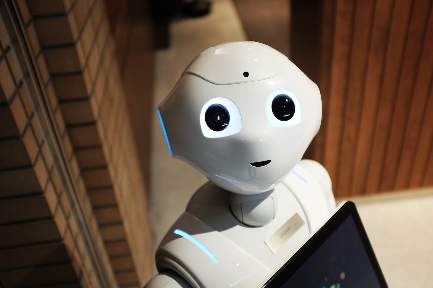 Humanoid robot facing a camera in a lab setting